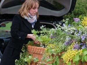 Woman adding flowers onto a coffin