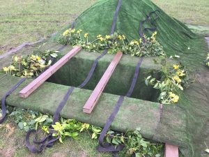 Natural burial grave decorated with flowers from the garden