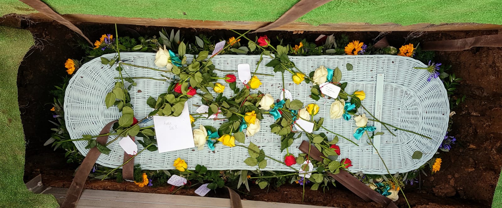 Wicker coffin in natural grave