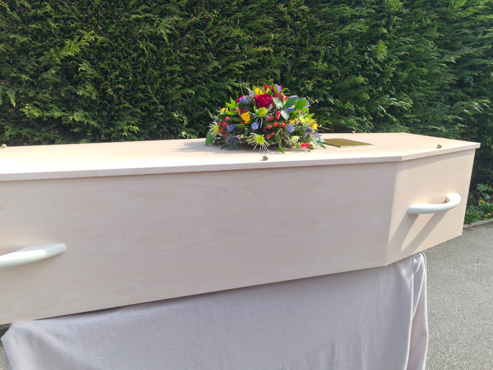 Life Art coffin in Ash with vibrant posy