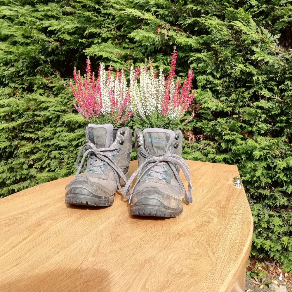 Heather in walking boots on wooden coffin